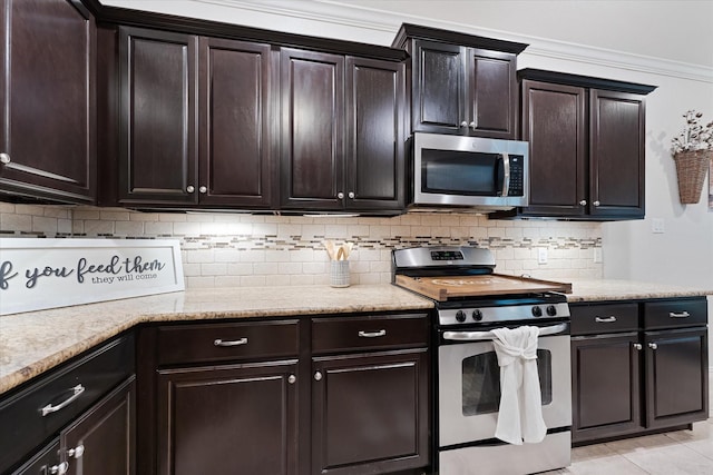 kitchen featuring stainless steel appliances, tasteful backsplash, dark brown cabinetry, and light stone counters