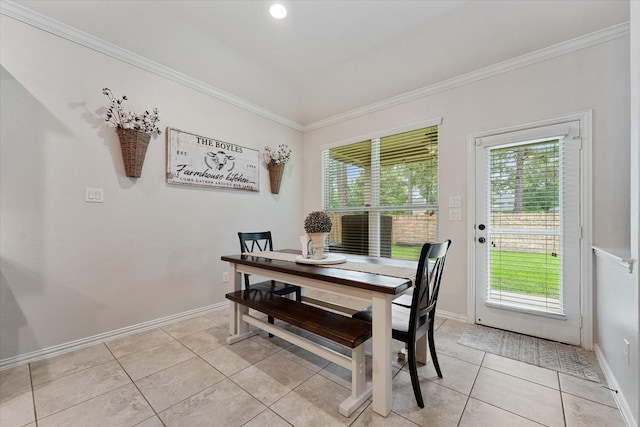 dining area with light tile patterned floors, ornamental molding, and baseboards
