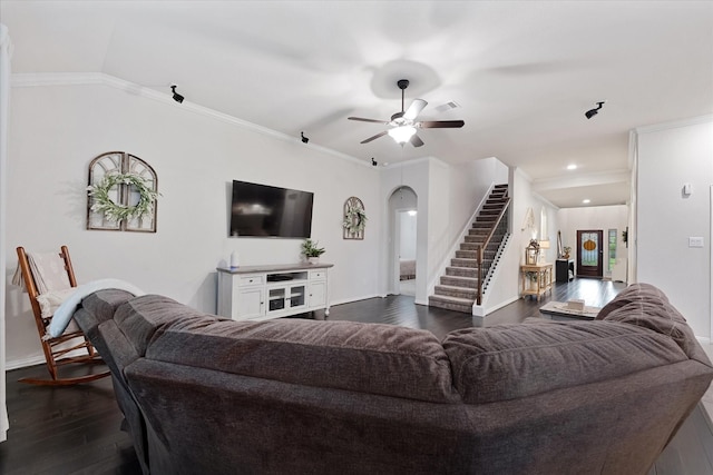 living room with dark wood-style floors, arched walkways, stairway, baseboards, and a ceiling fan