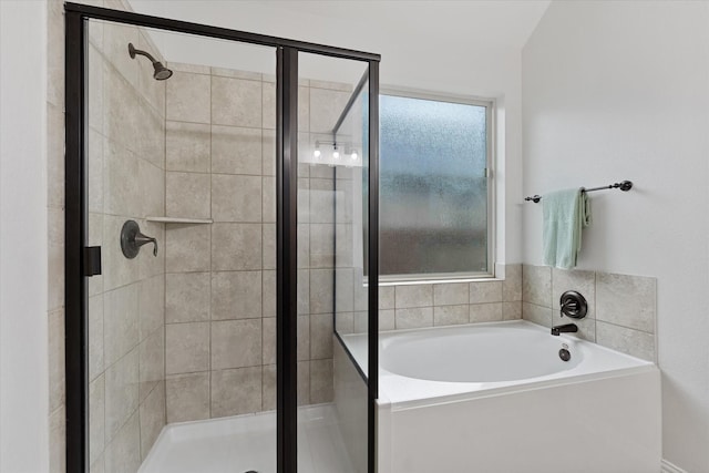 bathroom featuring a shower stall and a garden tub