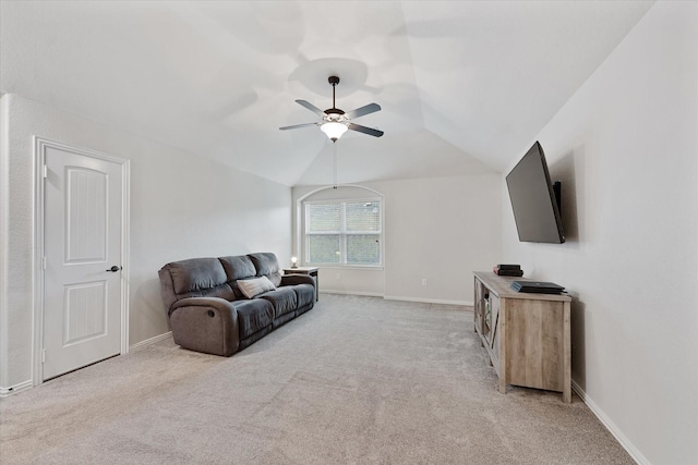 living room featuring light carpet, a ceiling fan, baseboards, and lofted ceiling