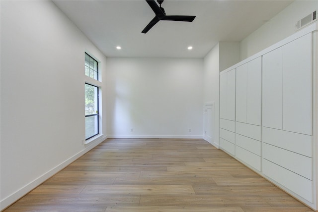 spare room featuring light wood-style flooring, visible vents, baseboards, recessed lighting, and a ceiling fan