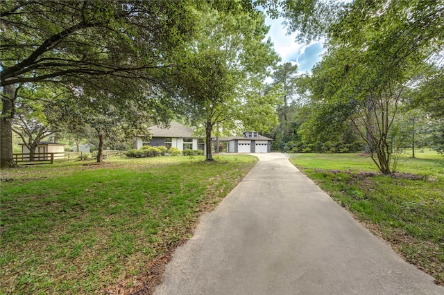 ranch-style house featuring a front yard, a garage, and aphalt driveway
