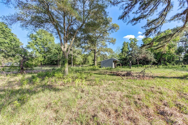 view of yard featuring an outbuilding and a rural view