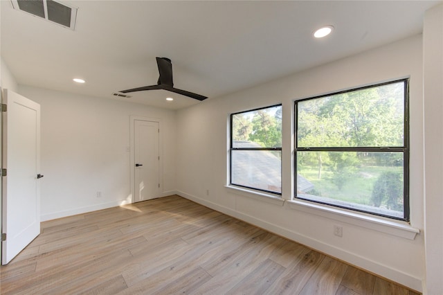 empty room with light wood-type flooring, visible vents, a ceiling fan, and recessed lighting