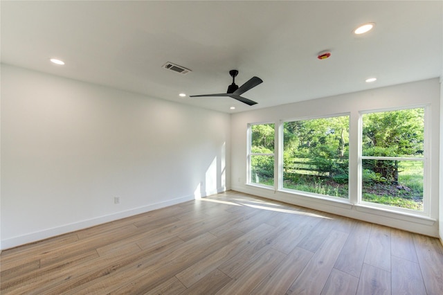 empty room featuring visible vents, wood finished floors, ceiling fan, and recessed lighting