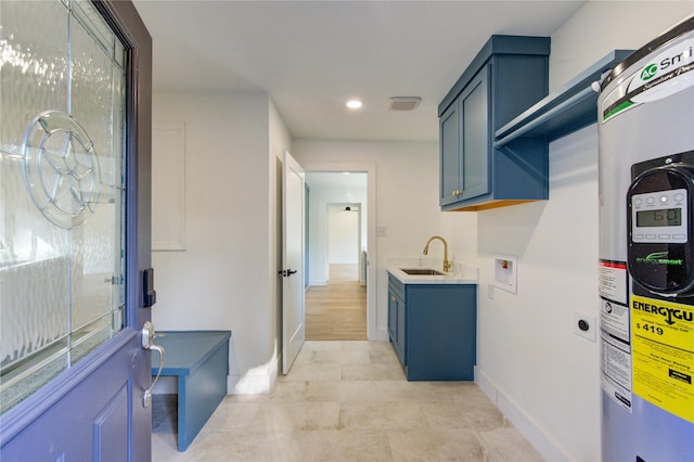 washroom with washer hookup, a sink, baseboards, water heater, and recessed lighting
