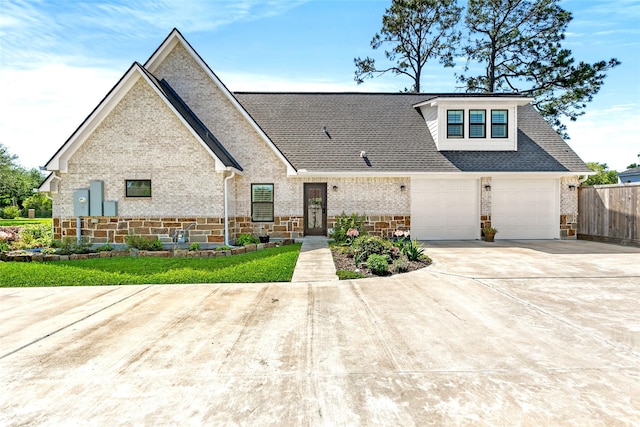 view of front of property featuring driveway, brick siding, fence, roof with shingles, and an attached garage