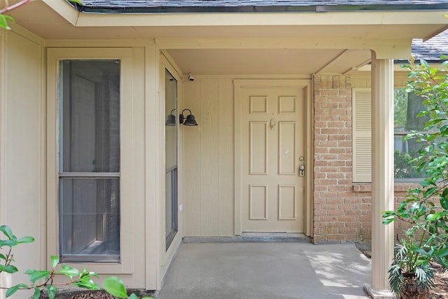 property entrance featuring brick siding