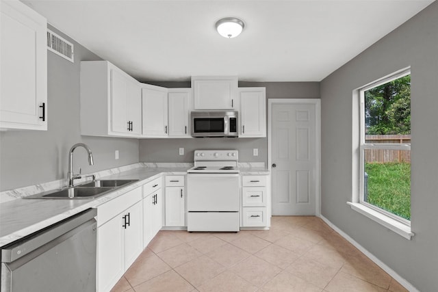kitchen featuring a sink, white cabinets, appliances with stainless steel finishes, and visible vents