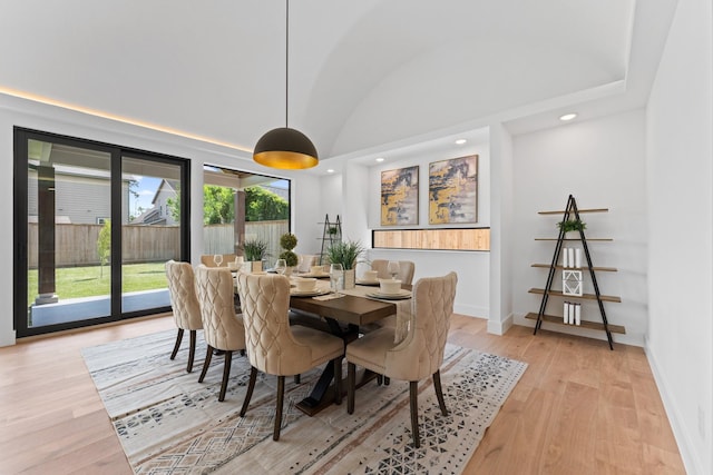dining space with recessed lighting, baseboards, vaulted ceiling, and light wood-style floors