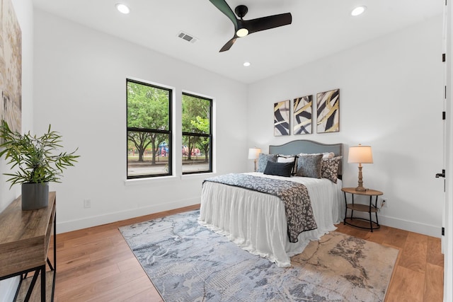 bedroom with visible vents, recessed lighting, baseboards, and wood finished floors