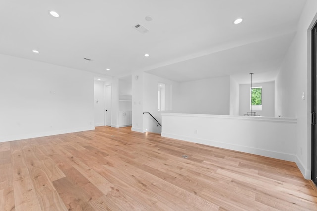 unfurnished room with recessed lighting, baseboards, and light wood finished floors