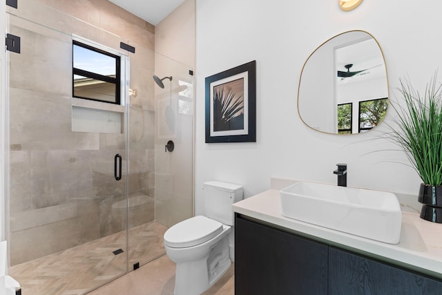 bathroom featuring a shower stall, toilet, and a wealth of natural light