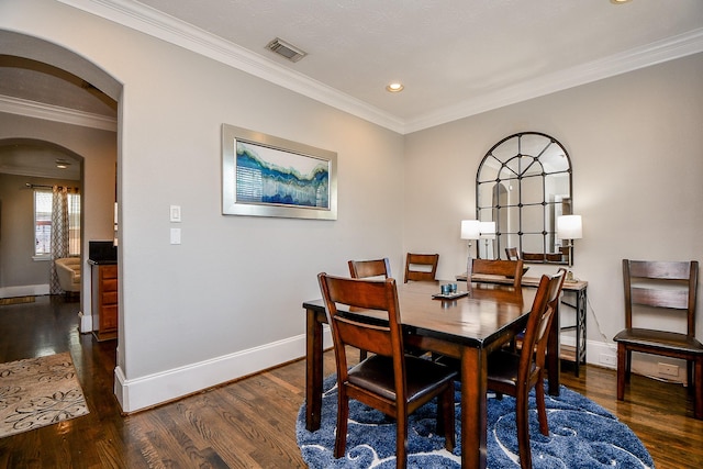 1708 Aden Mist Dr, Houston, TX 77003 - dining room with arched walkways, baseboards, wood finished floors, crown molding, and recessed lighting