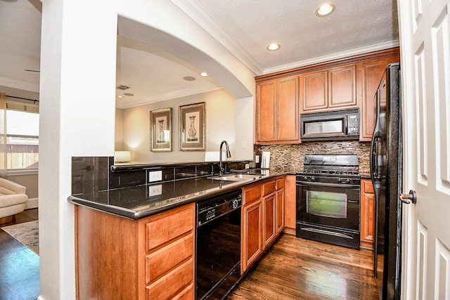 1708 Aden Mist Dr, Houston, TX 77003 - kitchen featuring black appliances, ornamental molding, a sink, dark wood-style flooring, and brown cabinetry