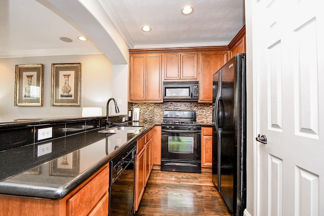 1708 Aden Mist Dr, Houston, TX 77003 - kitchen with black appliances, a sink, ornamental molding, brown cabinets, and a peninsula