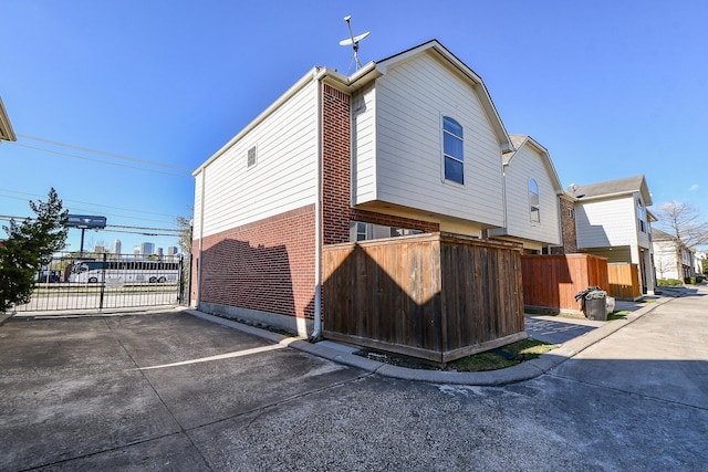 1708 Aden Mist Dr, Houston, TX 77003 - view of side of home with brick siding, a gate, and fence