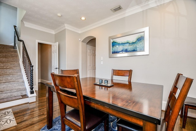 1708 Aden Mist Dr, Houston, TX 77003 - dining area featuring wood finished floors, arched walkways, ornamental molding, stairs, and recessed lighting