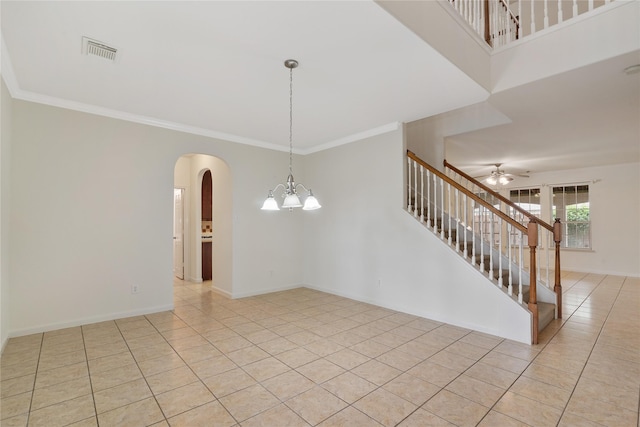 empty room with stairway, visible vents, arched walkways, light tile patterned flooring, and a ceiling fan