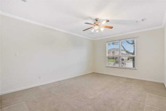 spare room with a ceiling fan, ornamental molding, and light carpet
