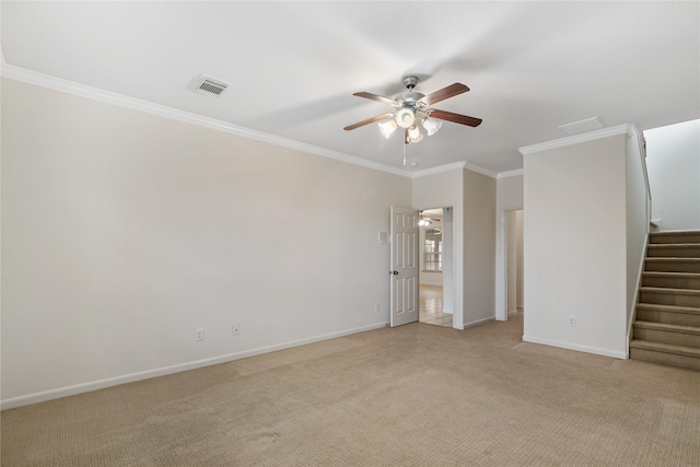 unfurnished room with light colored carpet, ornamental molding, ceiling fan, baseboards, and visible vents