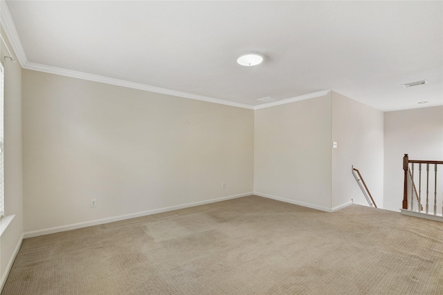 unfurnished room with baseboards, visible vents, light carpet, and crown molding