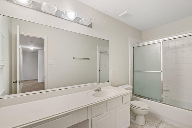 bathroom featuring shower / bath combination with glass door, visible vents, toilet, tile patterned floors, and vanity