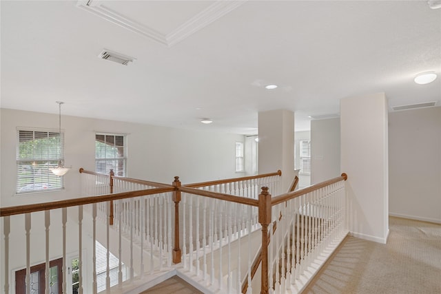 hall featuring baseboards, visible vents, an upstairs landing, and carpet flooring