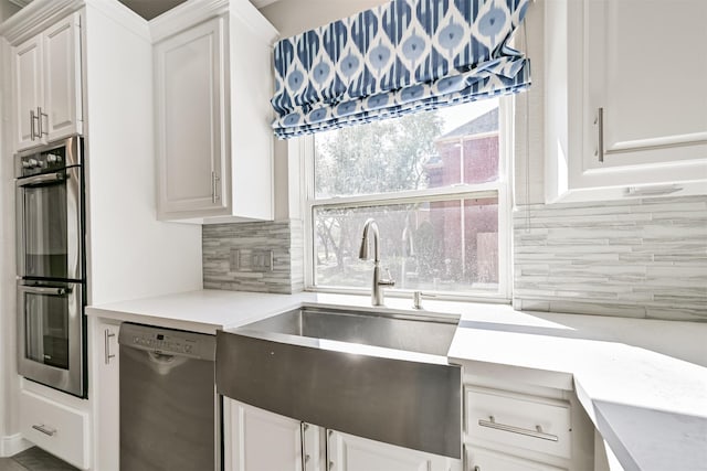 3430 Williams Glen Dr, Sugar Land, TX 77479 - kitchen with appliances with stainless steel finishes, a sink, light countertops, and tasteful backsplash