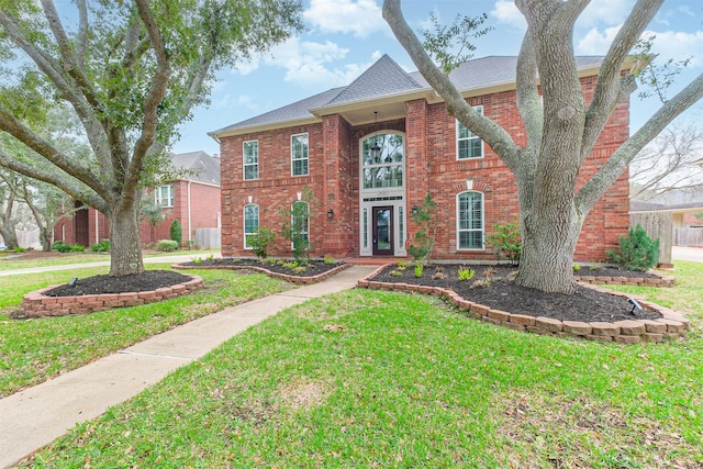 3430 Williams Glen Dr, Sugar Land, TX 77479 - colonial inspired home featuring a front lawn, brick siding, and a shingled roof