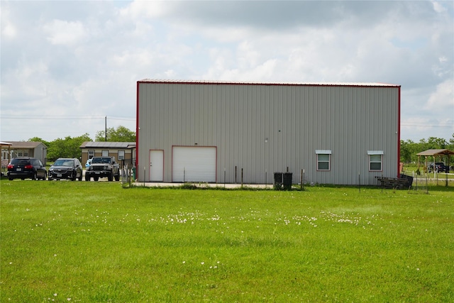view of pole building featuring a lawn and central AC unit