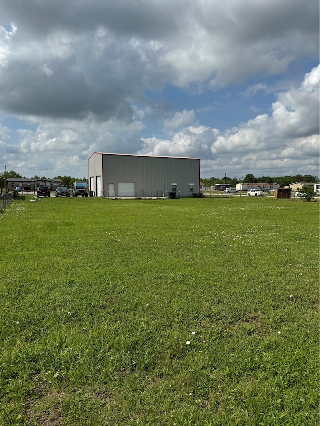 view of yard with an outbuilding, an outdoor structure, and a garage