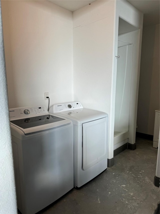 laundry area with washing machine and clothes dryer and laundry area