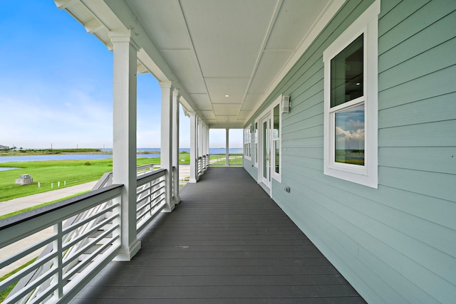 wooden terrace featuring a water view