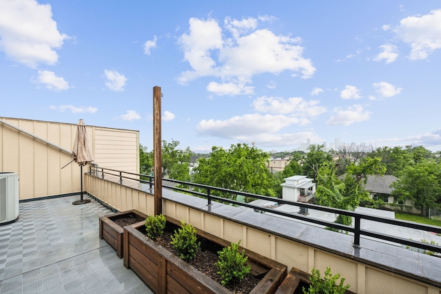 view of patio / terrace with central AC unit and a balcony