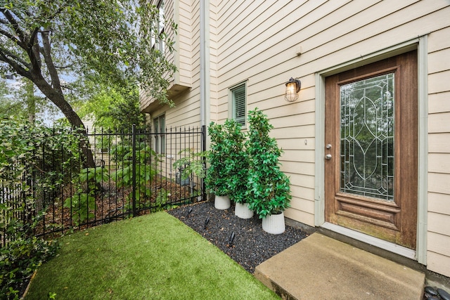 entrance to property featuring fence