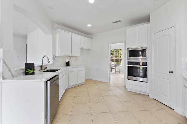kitchen with white cabinetry, a sink, visible vents, stainless steel appliances, and recessed lighting
