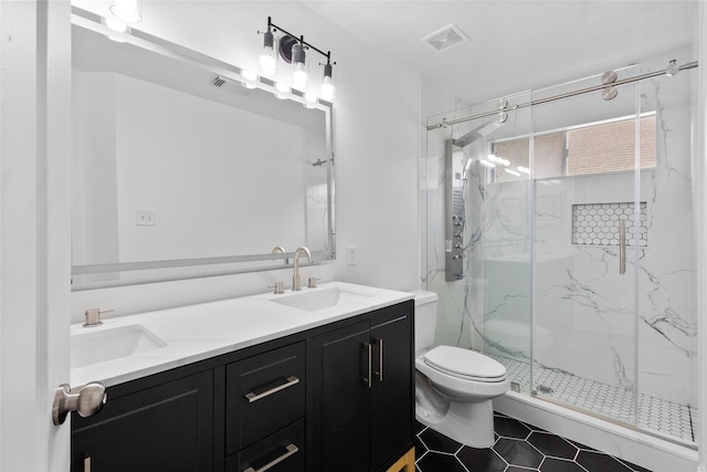 full bath featuring visible vents, toilet, a marble finish shower, and a sink