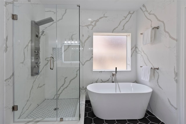 full bathroom featuring tile patterned floors, a soaking tub, and a marble finish shower