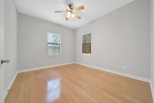 empty room featuring baseboards, ceiling fan, and light wood finished floors