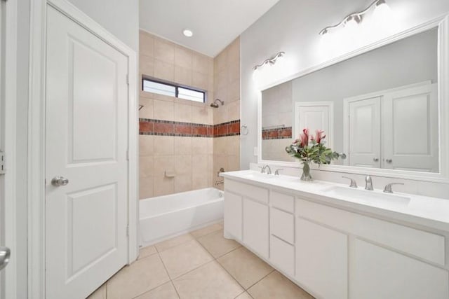 bathroom with shower / tub combination, a sink, double vanity, and tile patterned floors