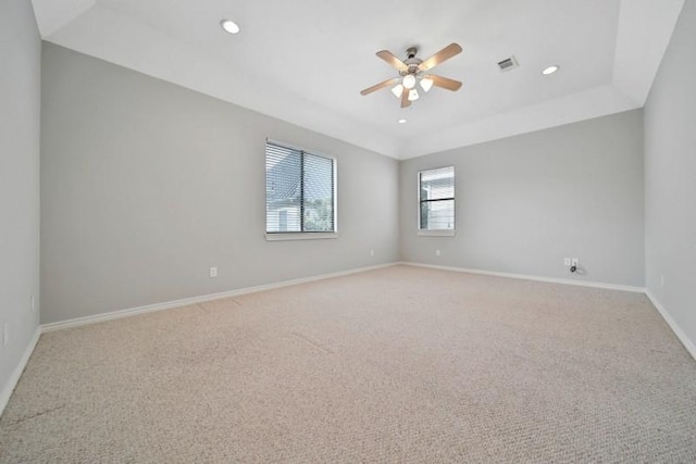 unfurnished room with visible vents, ceiling fan, light carpet, and baseboards