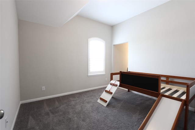 carpeted bedroom featuring baseboards and lofted ceiling
