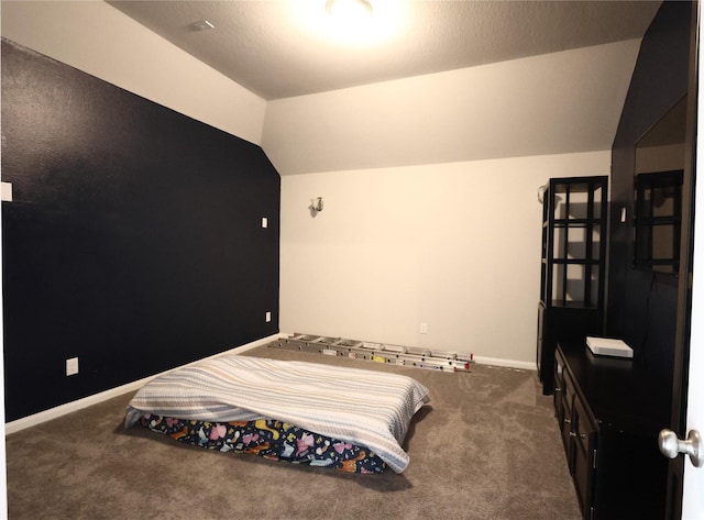 bedroom with baseboards, carpet flooring, and lofted ceiling