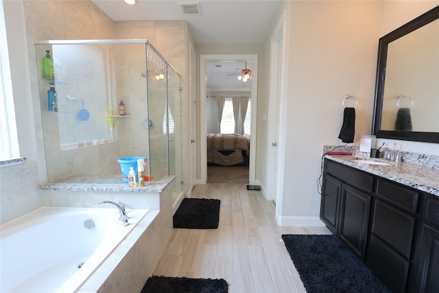 bathroom with visible vents, a garden tub, ceiling fan, and a stall shower