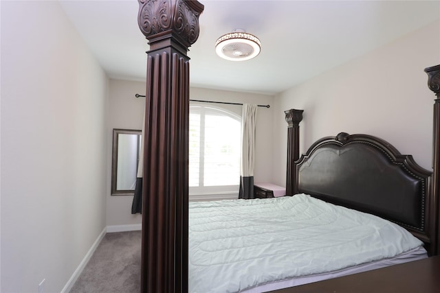 bedroom featuring carpet floors, baseboards, and ornate columns