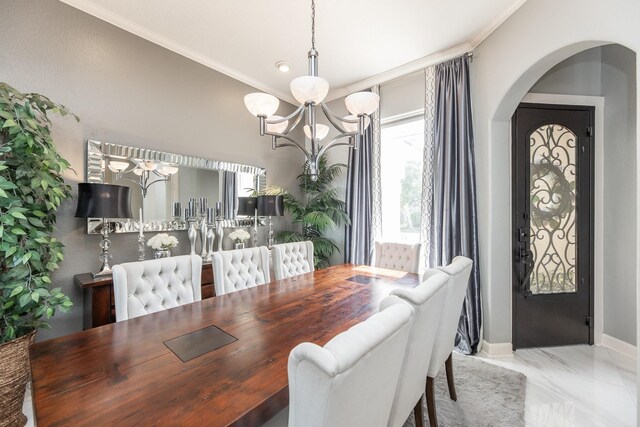 dining room featuring arched walkways, an inviting chandelier, marble finish floor, baseboards, and crown molding