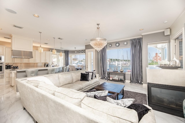 living area with crown molding, marble finish floor, visible vents, and a wealth of natural light