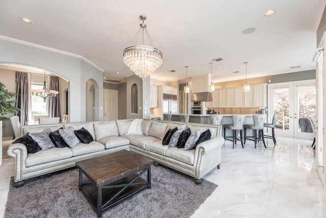 living room featuring recessed lighting, an inviting chandelier, marble finish floor, ornamental molding, and arched walkways